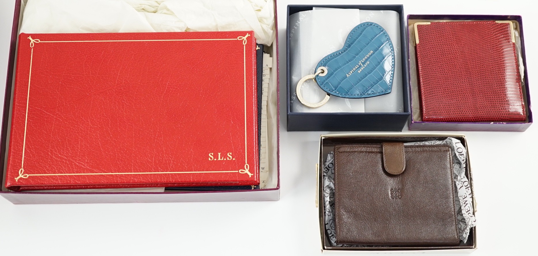 A set of two Asprey leather address books (initialled), an Asprey snakeskin wallet, a Loewe brown leather wallet and an Aspinal heart key fob